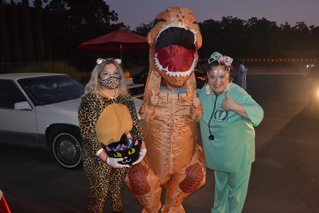These costumed characters helped distribute gifts during Saturday night's Drive-thru Trunk and Treat held at the church site, located at 501 East Bush Street. Hundreds of cars line dup on Bush Street.